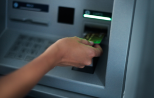 Person putting card into an ATM