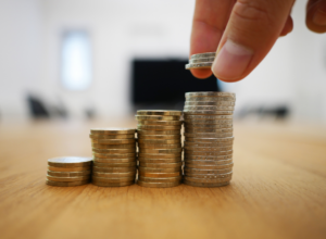 Person counting coins in stacks that look like Medina County